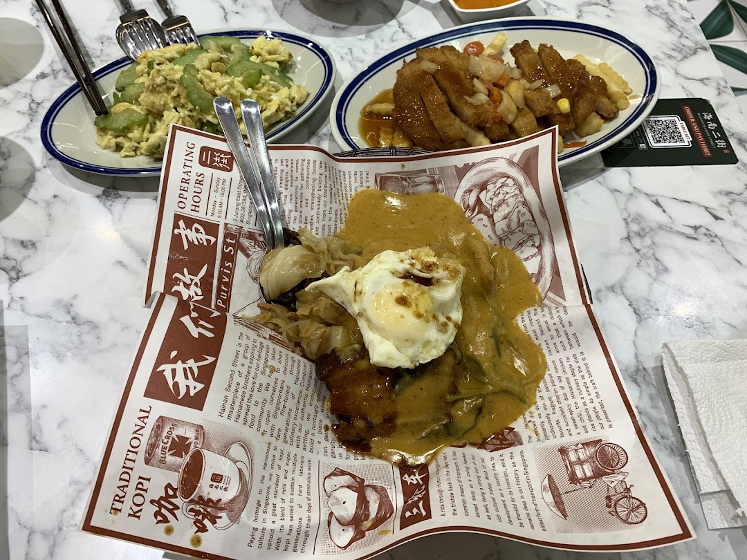 Multiple dishes of food, including a sauced main, served on a marble table.