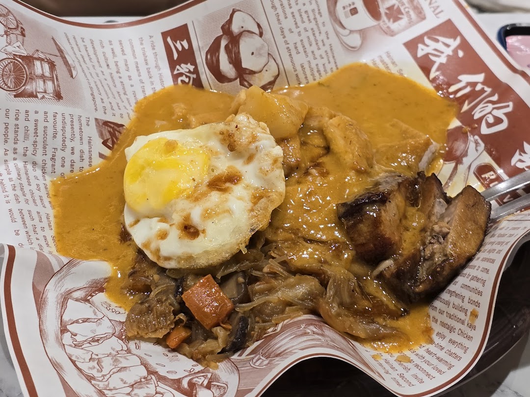 Close-up of a food dish with egg, meat, and sauce on paper.