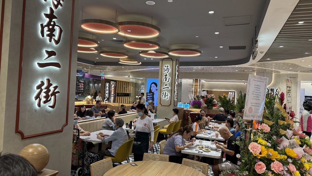 Interior view of a busy restaurant with customers dining and staff working.