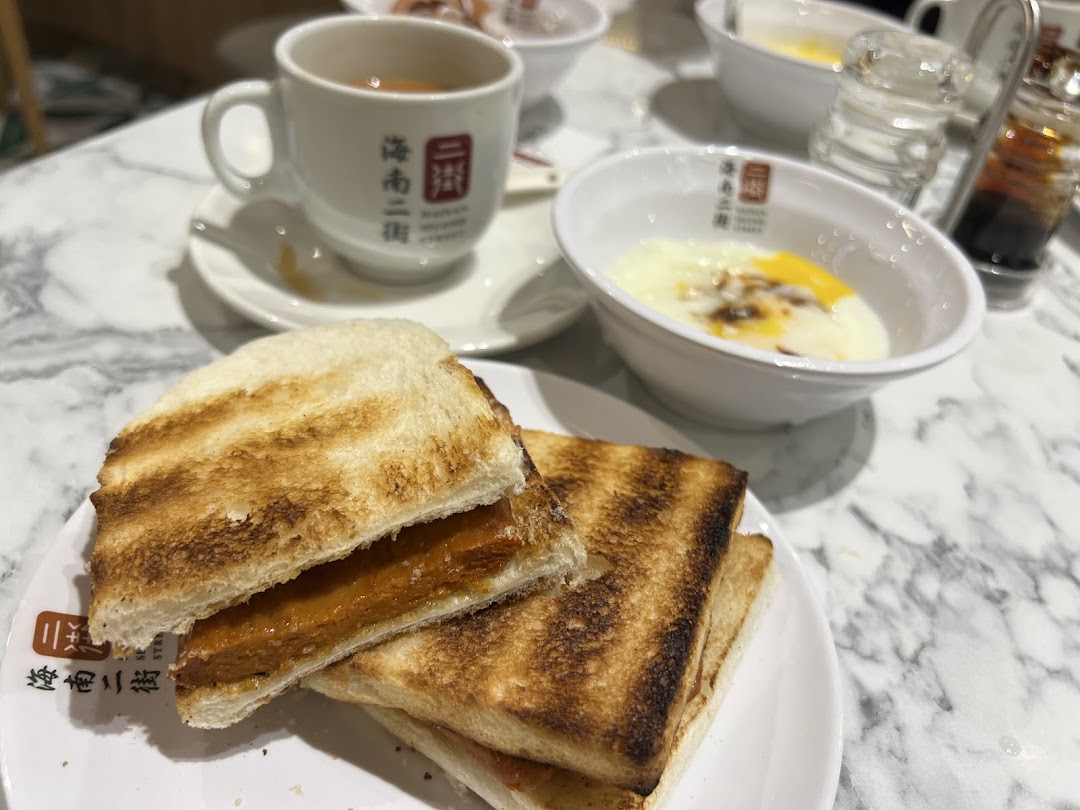Toast, soft-boiled eggs, and a drink on a marble table.