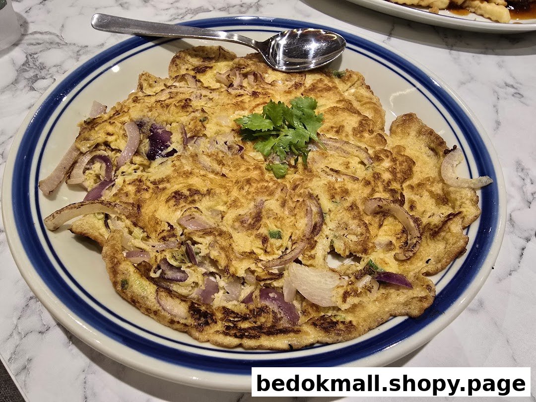 A plate of omelet with onions and cilantro, served on a table.