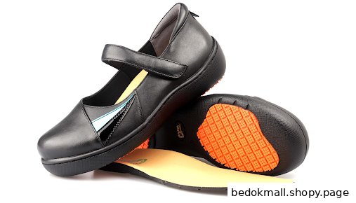 A pair of black shoes with an orange sole pattern and an insole.