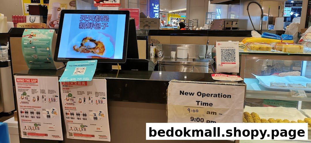 Counter of a food stall with a digital display, food items, and operational signs.