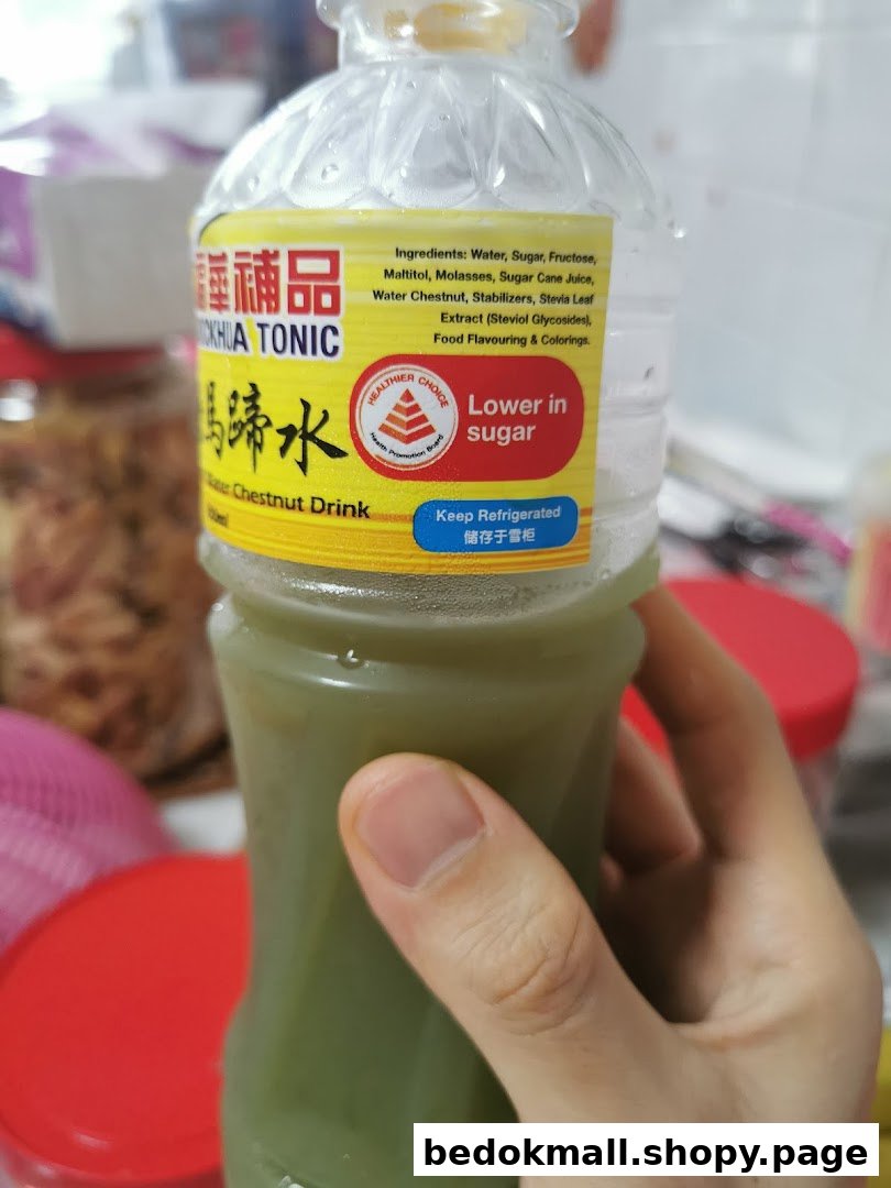 Person holding a bottle of Hockhua Tonic Water Chestnut Drink.
