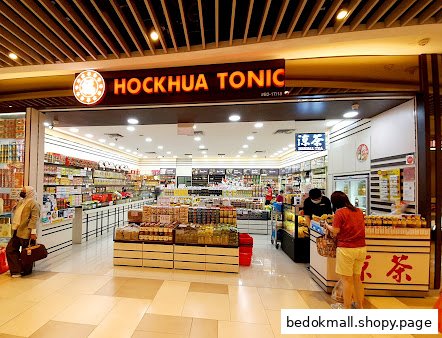 Shop entrance with products displayed and customers inside.