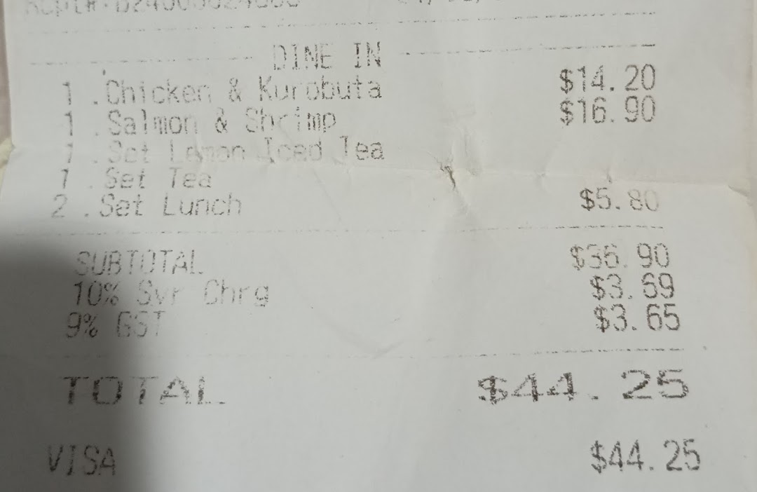 Close-up of a printed receipt showing food items, prices, and total.