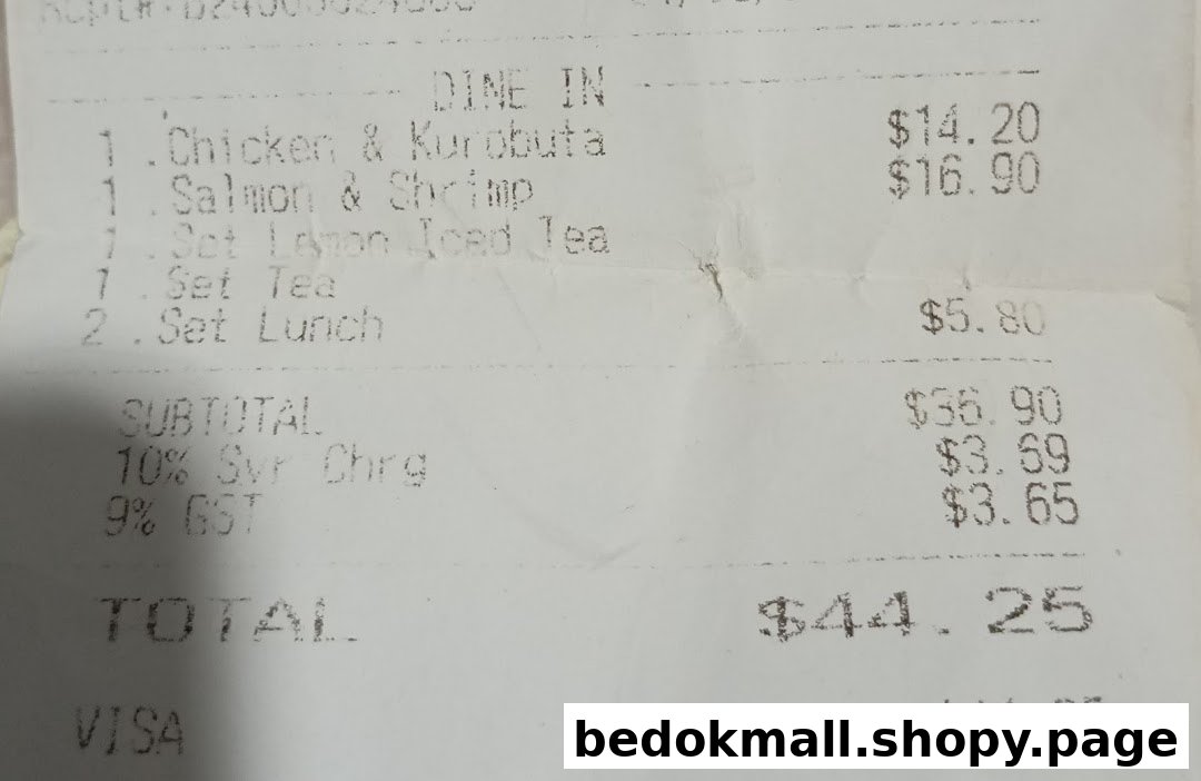 Close-up of a printed receipt showing food items, prices, and total.
