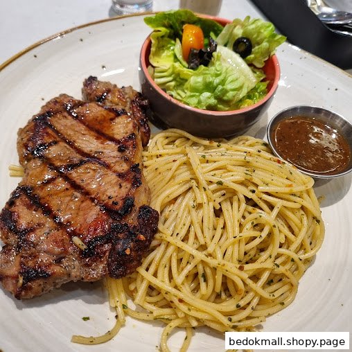 A plate of grilled steak, spaghetti, salad, and sauce.