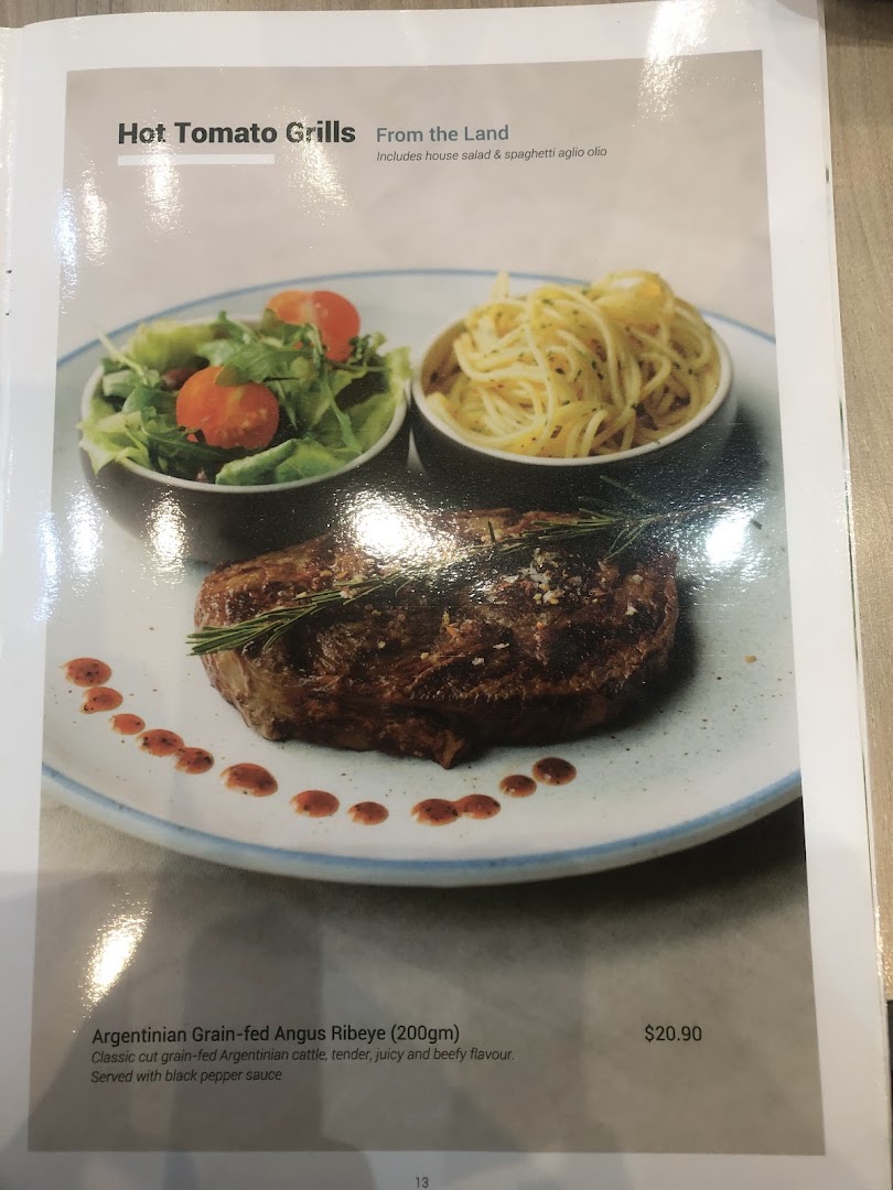 Menu page displaying a steak dish with salad and pasta.