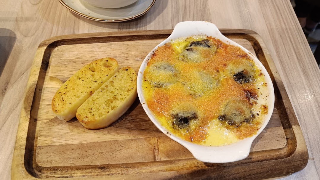 Baked dish with garlic bread served on a wooden board.