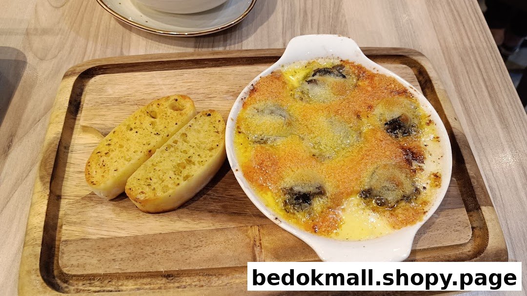 Baked dish with garlic bread served on a wooden board.