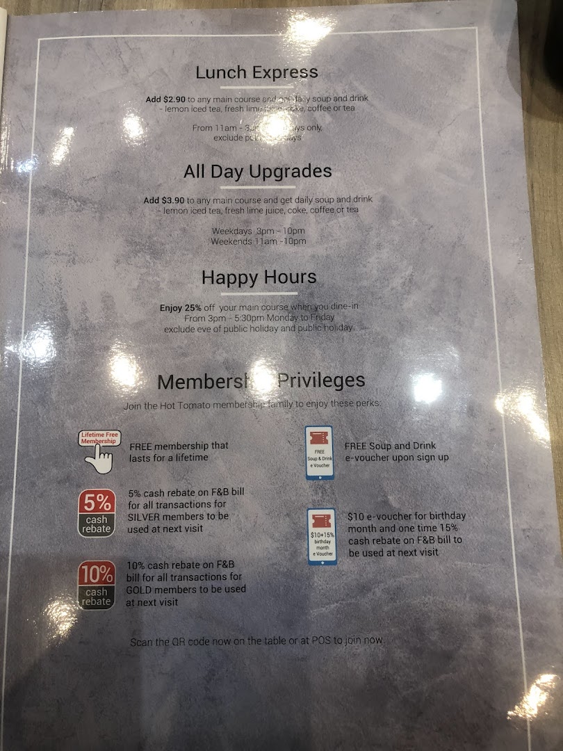A printed menu displaying lunch specials, upgrades, happy hours, and membership privileges.