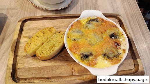 Baked dish with garlic bread served on a wooden board.