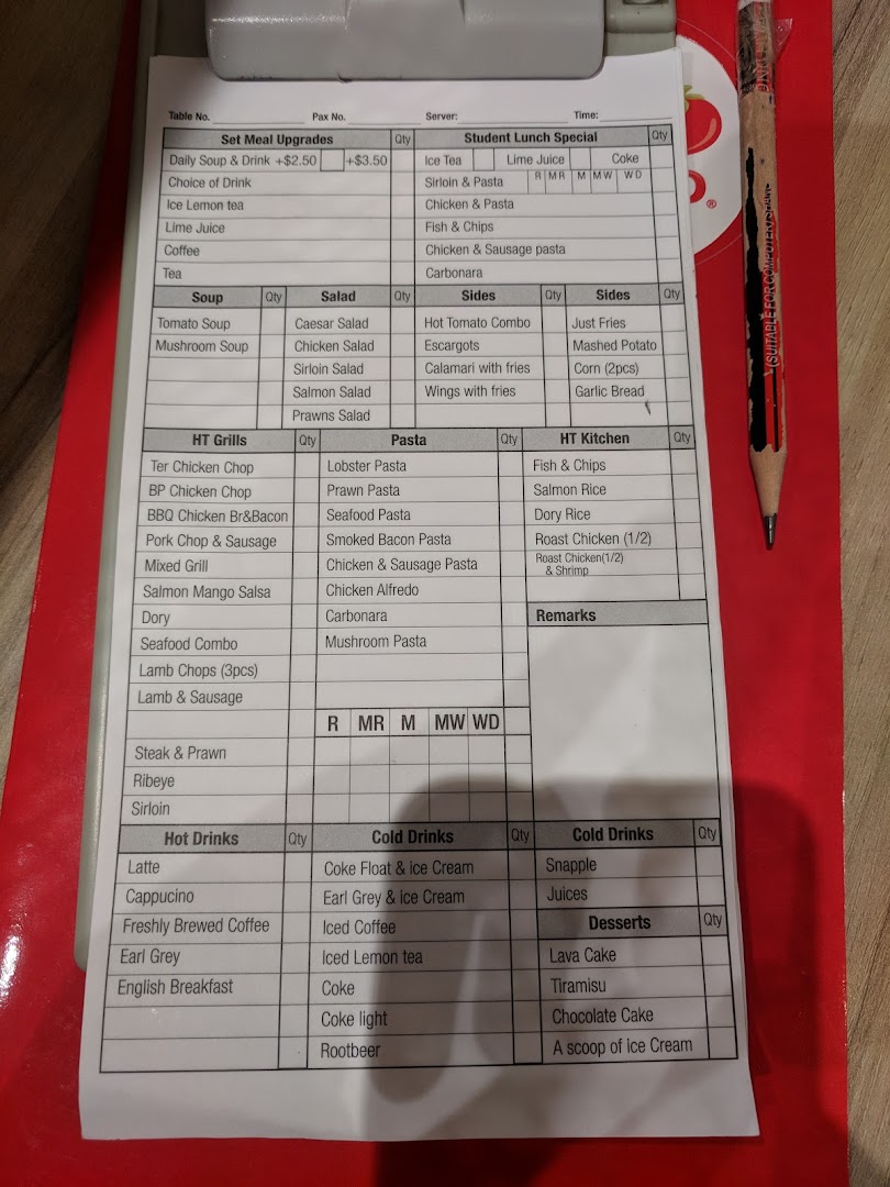 A detailed food and drink menu/order form on a clipboard with a pencil.