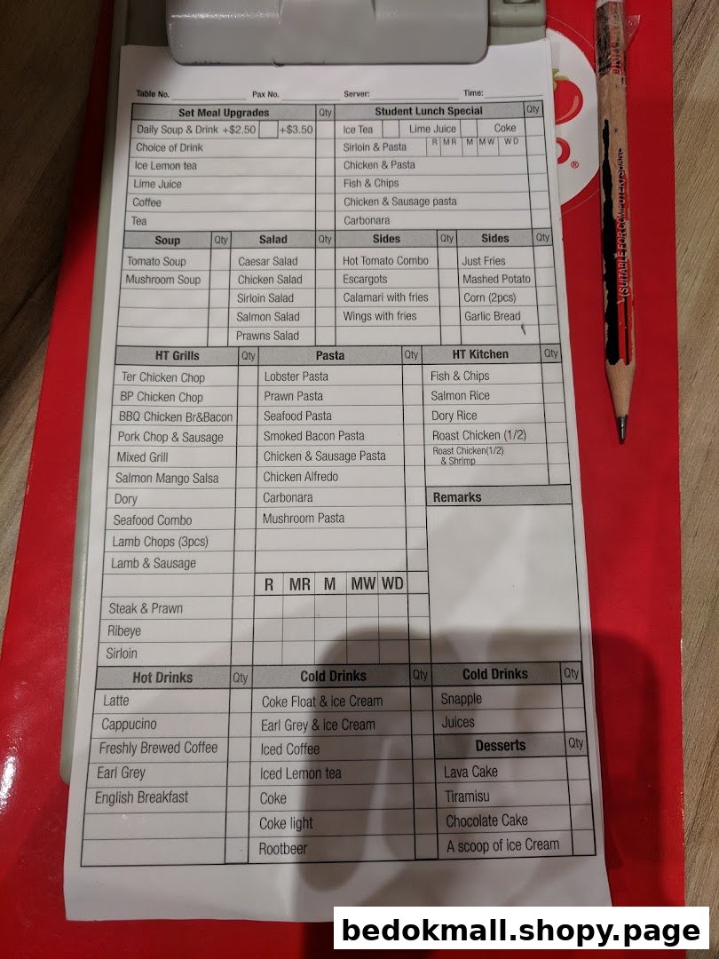 A detailed food and drink menu/order form on a clipboard with a pencil.