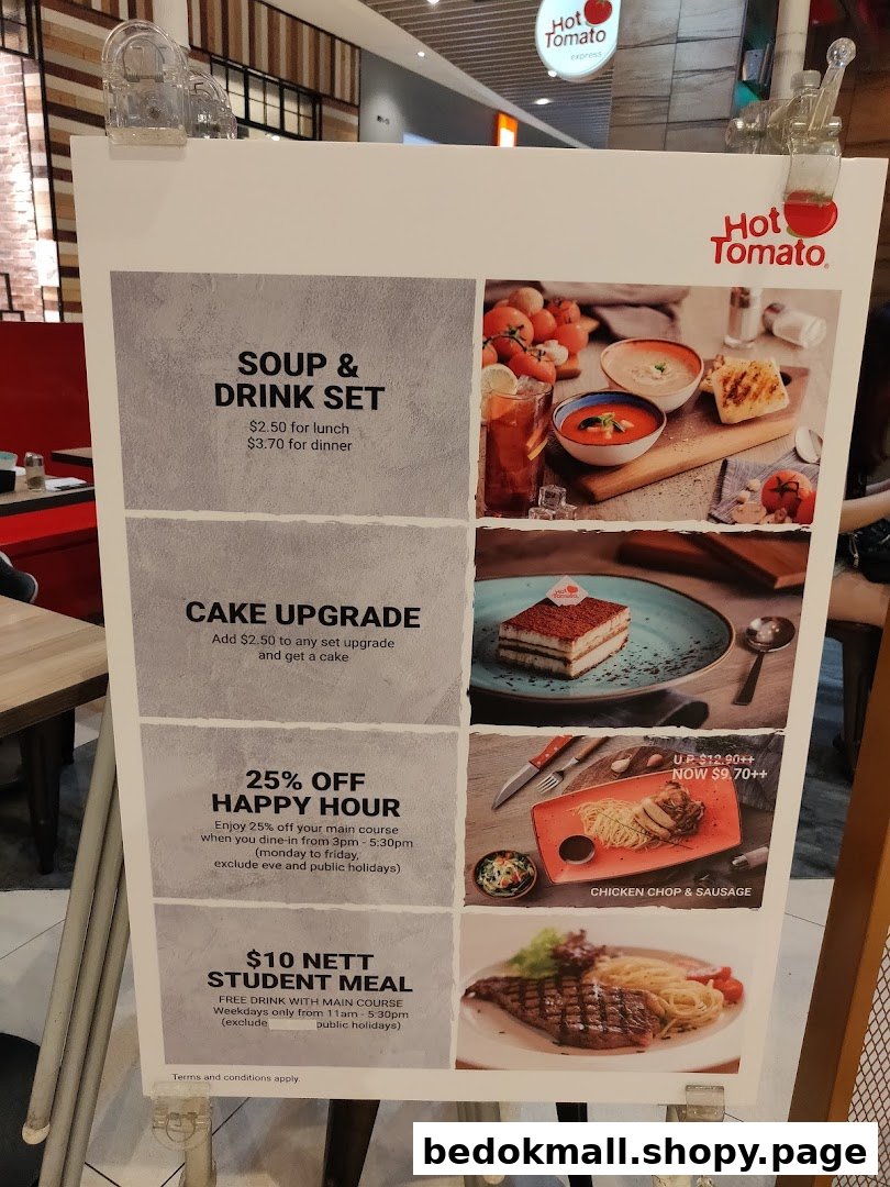 A large display board showing food items, prices, and promotions for Hot Tomato.