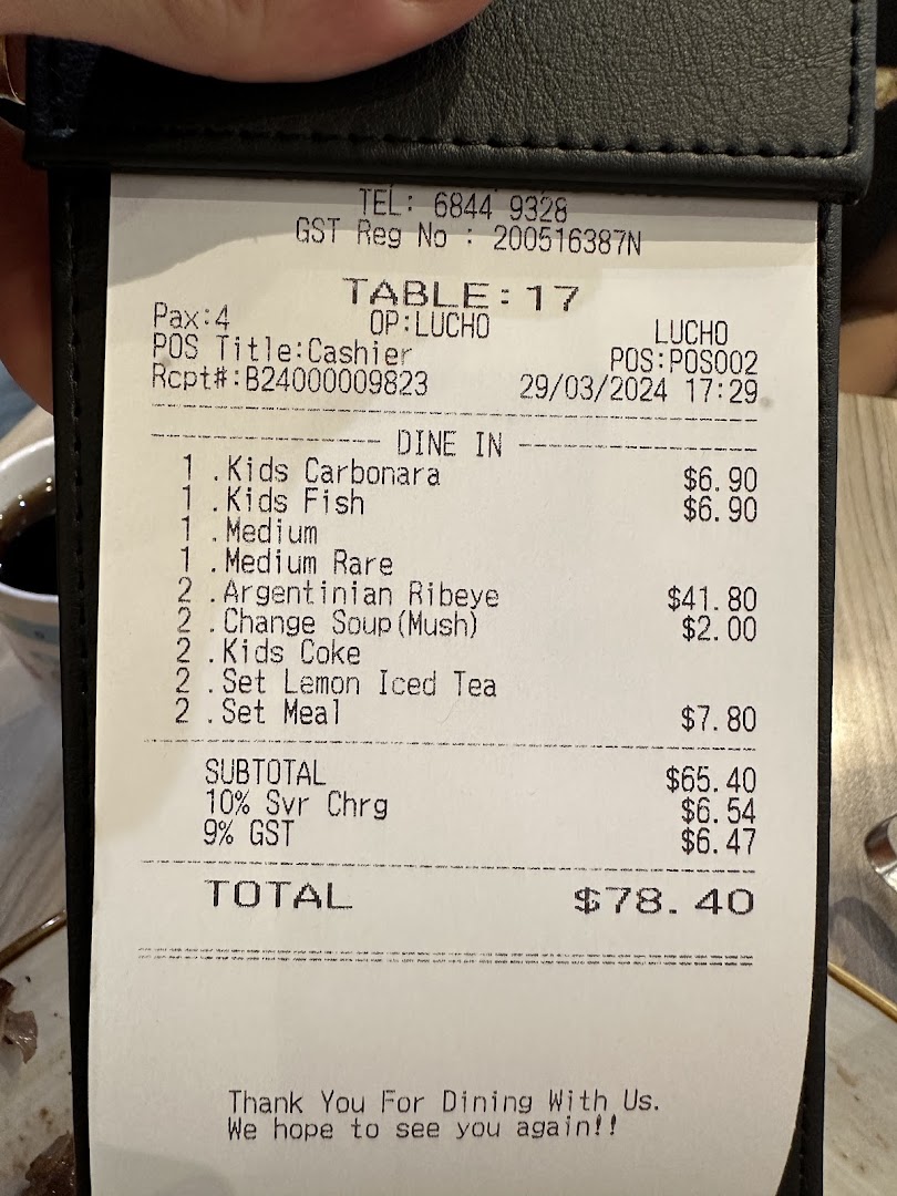 Close-up of a detailed dining receipt showing food items and total cost.
