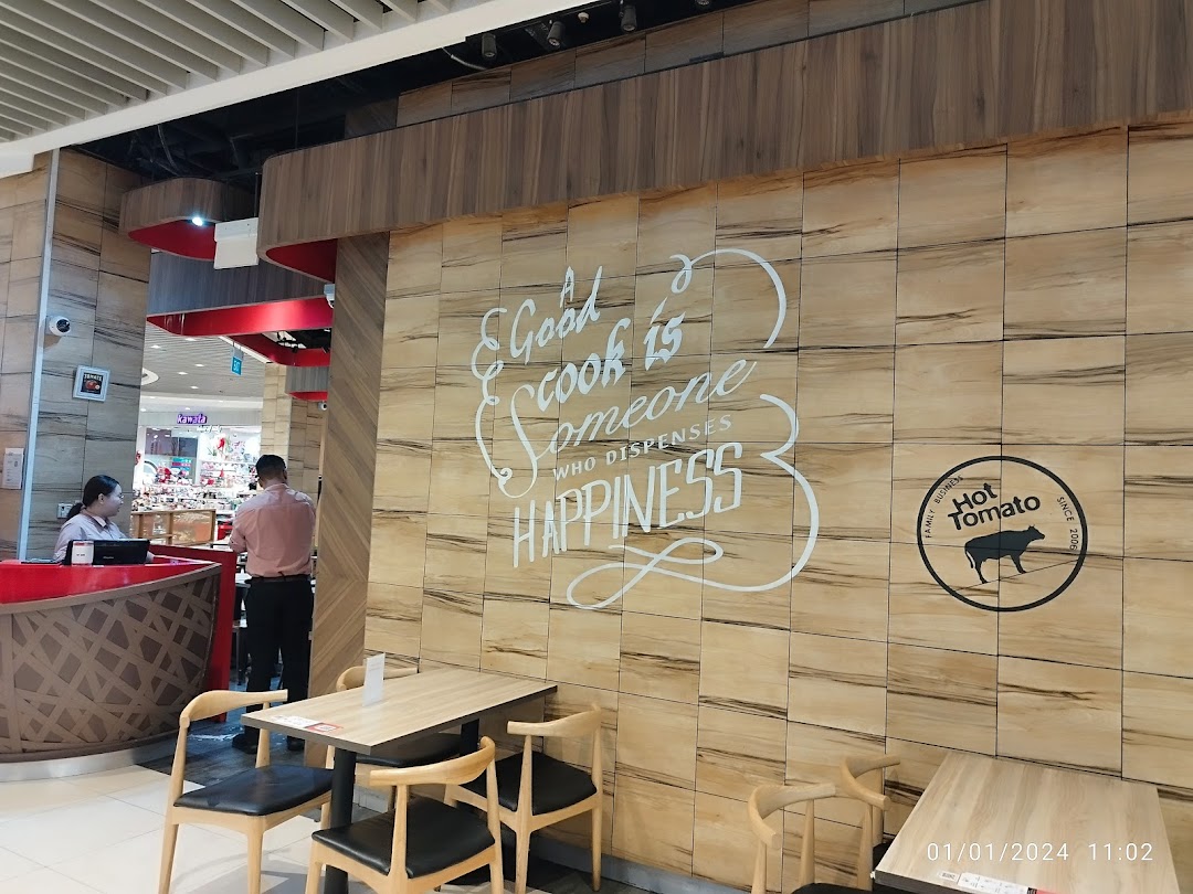 Interior view of Hot Tomato Bistro's entrance with reception desk and seating.