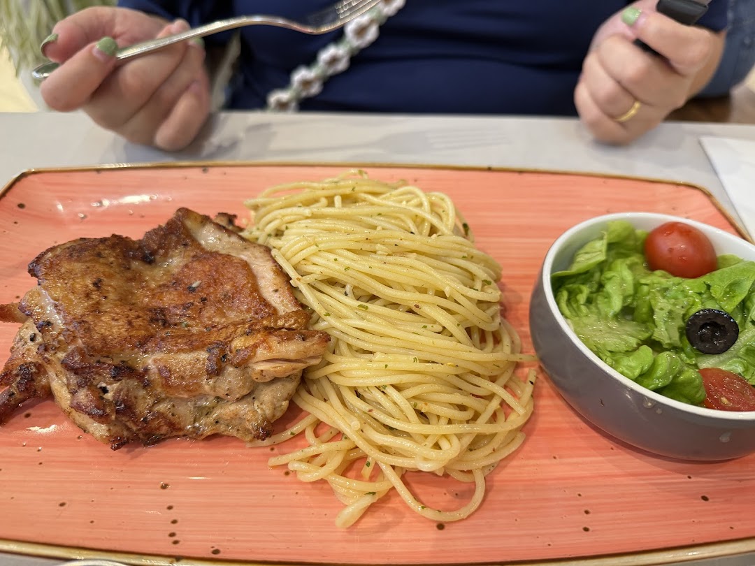 Plate with grilled chicken, spaghetti, and a side salad.