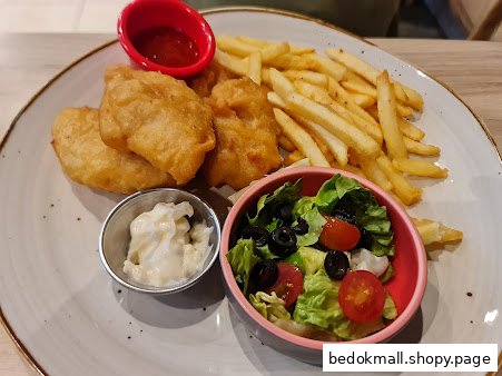 A plate of fried food, french fries, salad, and sauces.