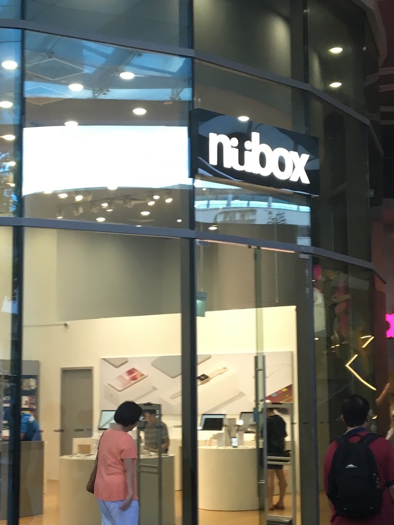 Glass shop front with 'nubox' sign and people visible inside.