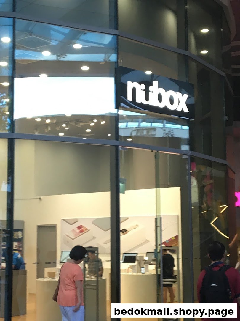 Glass shop front with 'nubox' sign and people visible inside.