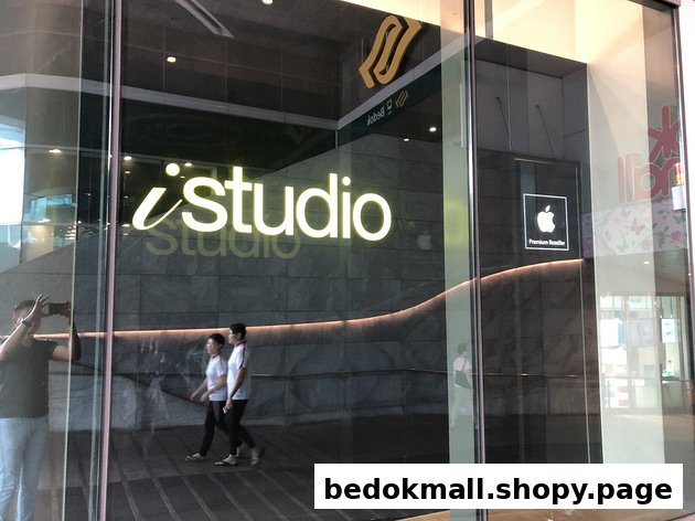 Glass shop front of iStudio with Apple Premium Reseller sign.