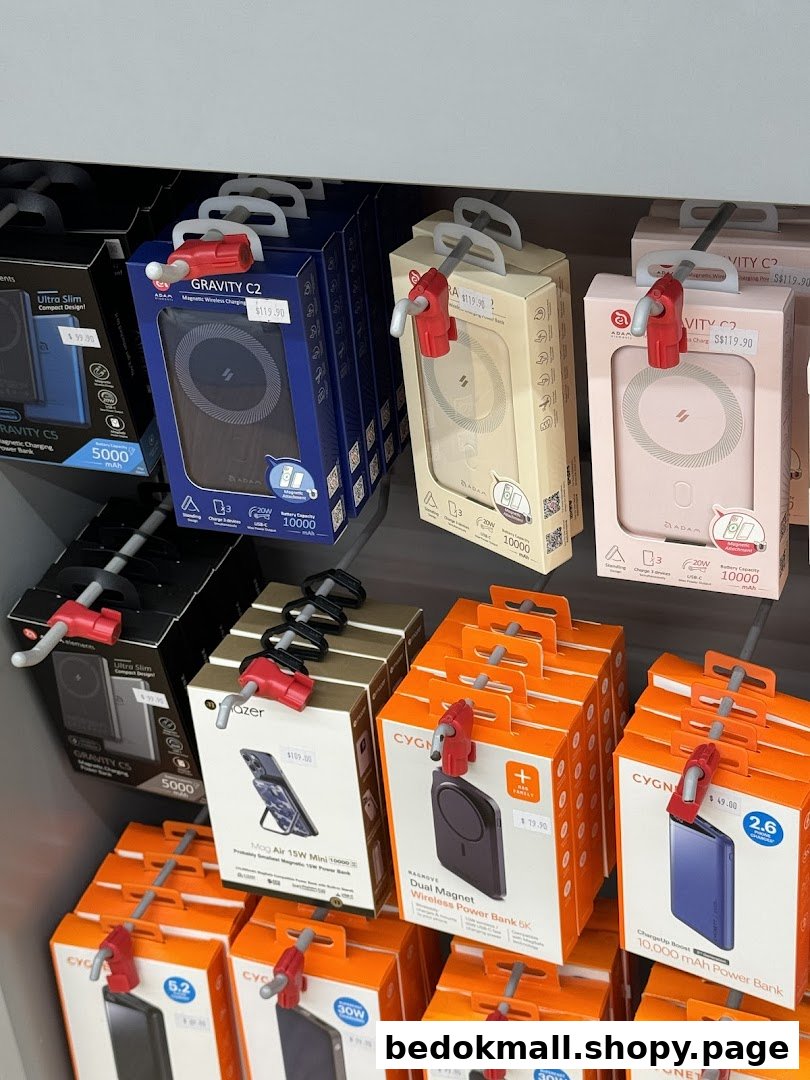 Electronic products in boxes are displayed on a retail shelf with prices.