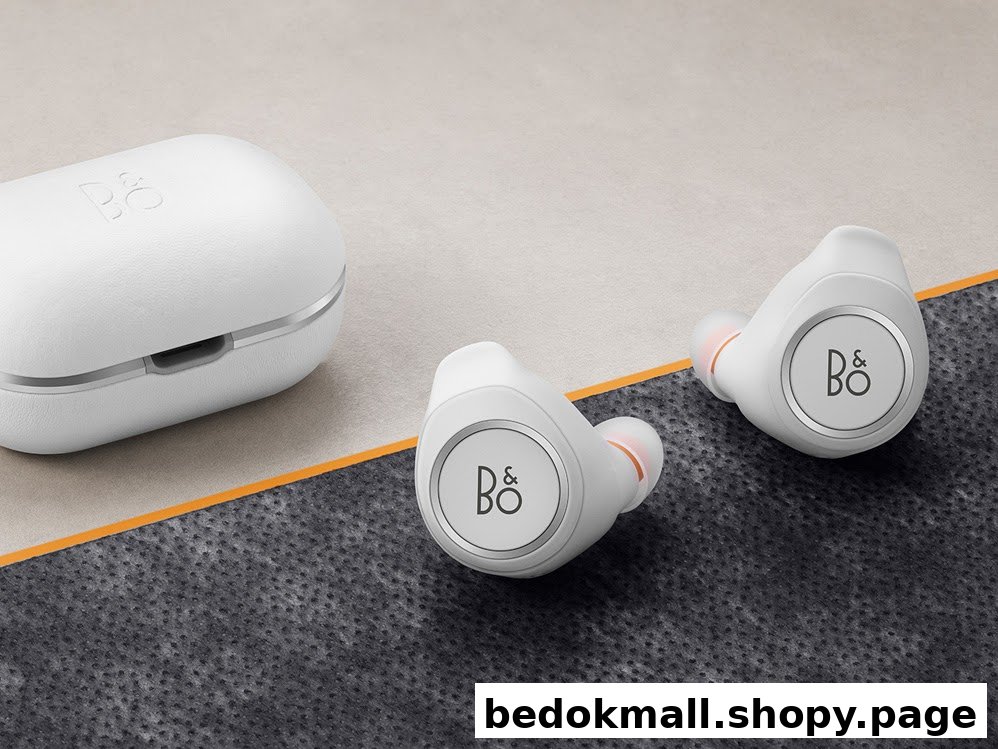 White wireless earbuds and their charging case on a textured surface.