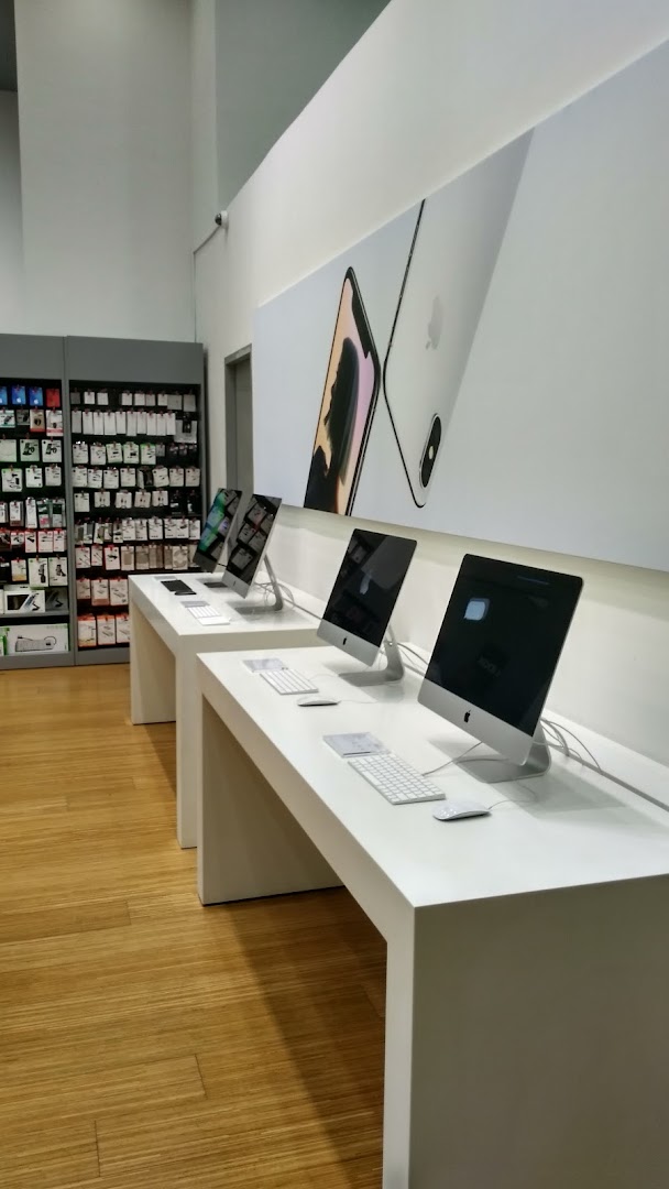 Interior view of a tech store with computers on display and accessories.