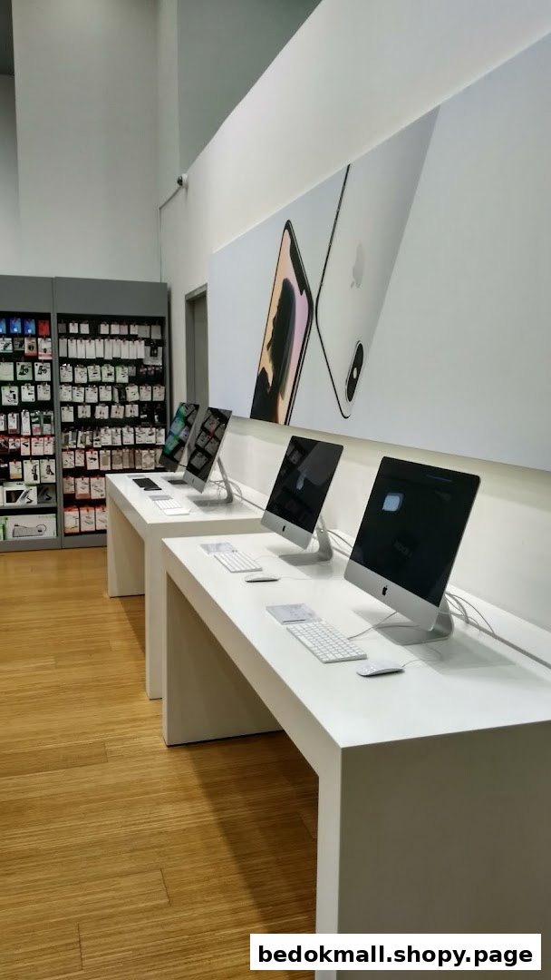Interior view of a tech store with computers on display and accessories.