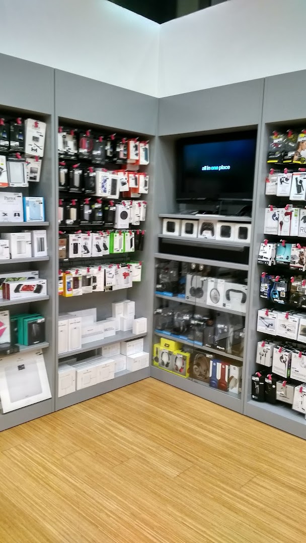 Interior view of a retail shop displaying electronic accessories and products on shelves.