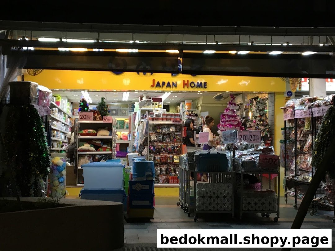 Night view of Japan Home shop front with products displayed and people inside.