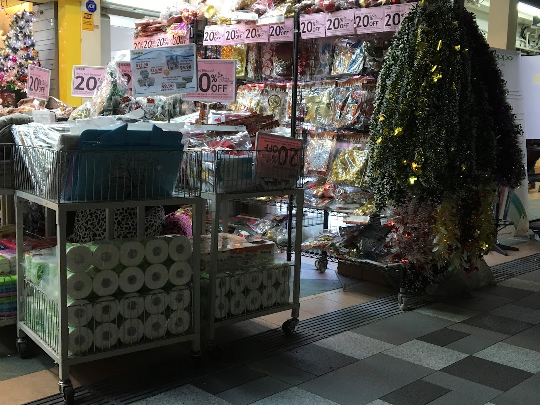 Interior view of a retail shop with products on display and discount signs.