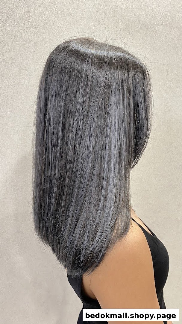 Back view of a person with long, straight grey/silver hair.