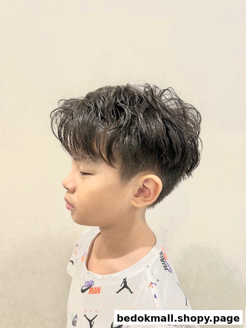 A child with a fresh haircut, viewed from the side.