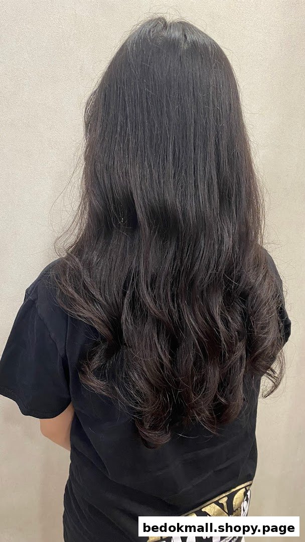 Back of person with long, dark, wavy hair.