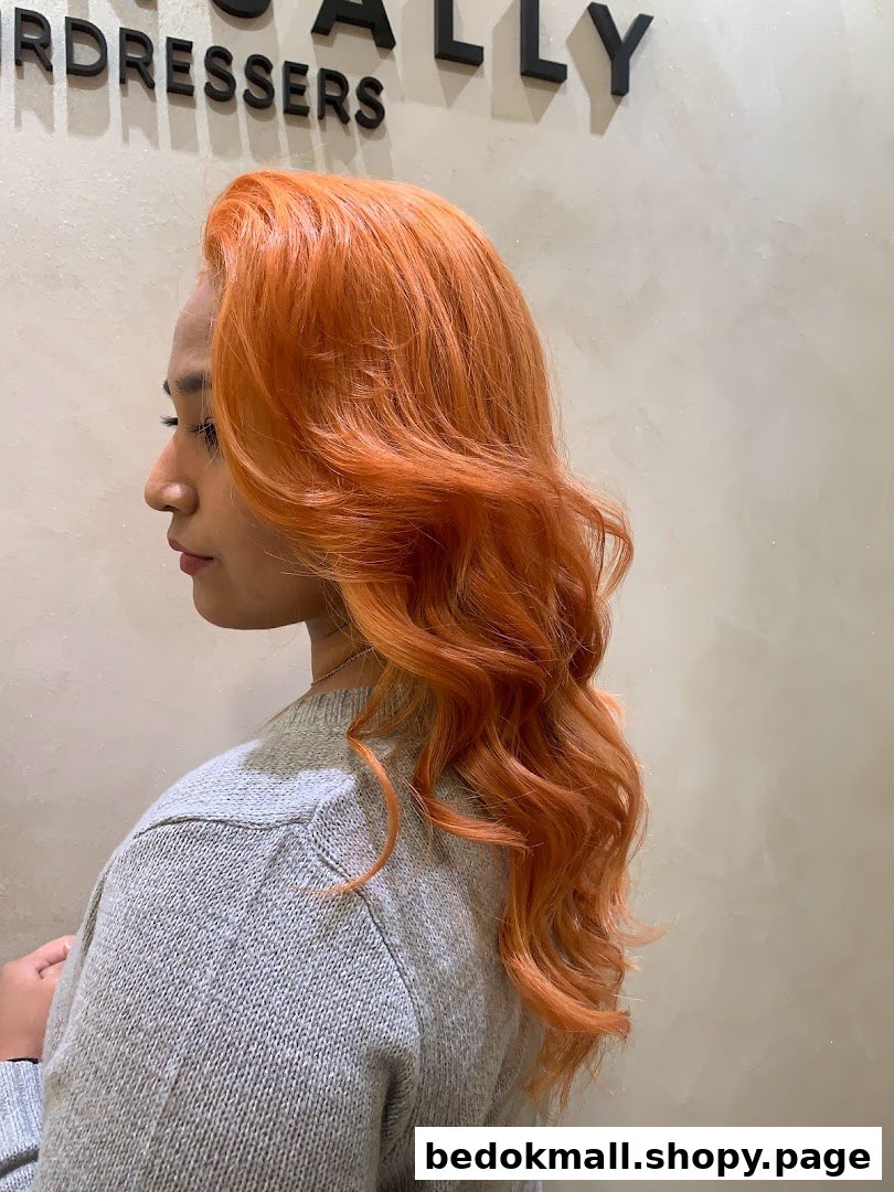 Person with vibrant orange hair in a salon setting, showing a hair service result.