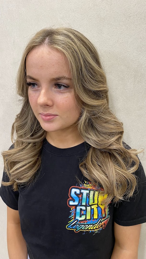 Close-up of a young woman with freshly styled blonde hair.