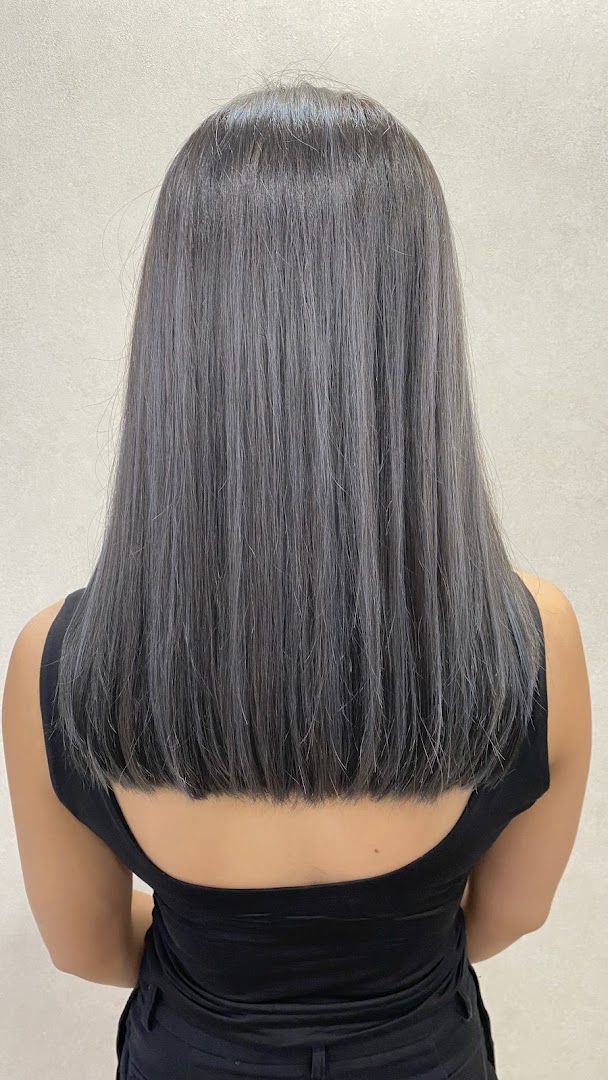Back of person with long, straight grey hair.