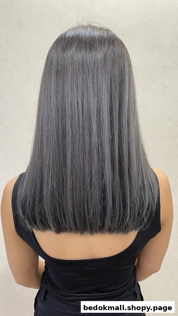 Back of person with long, straight grey hair.