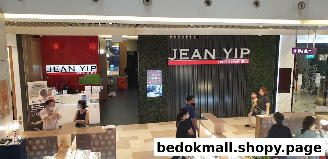 Exterior view of Jean Yip Hairdressing and Hairspa entrance with people.