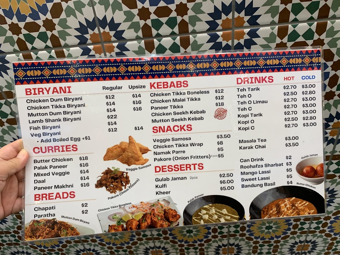 Close-up of a food and drink menu with prices and item categories.