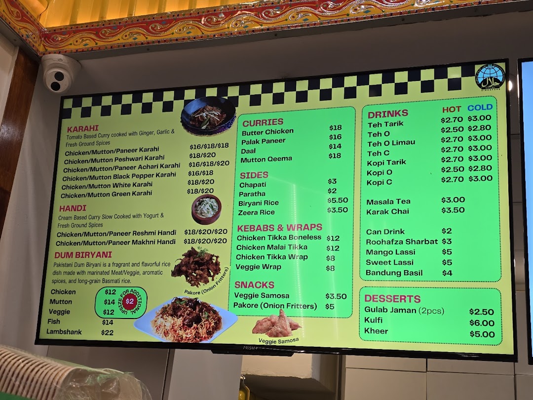 A vibrant digital menu board displaying a variety of Pakistani and Indian dishes with prices.