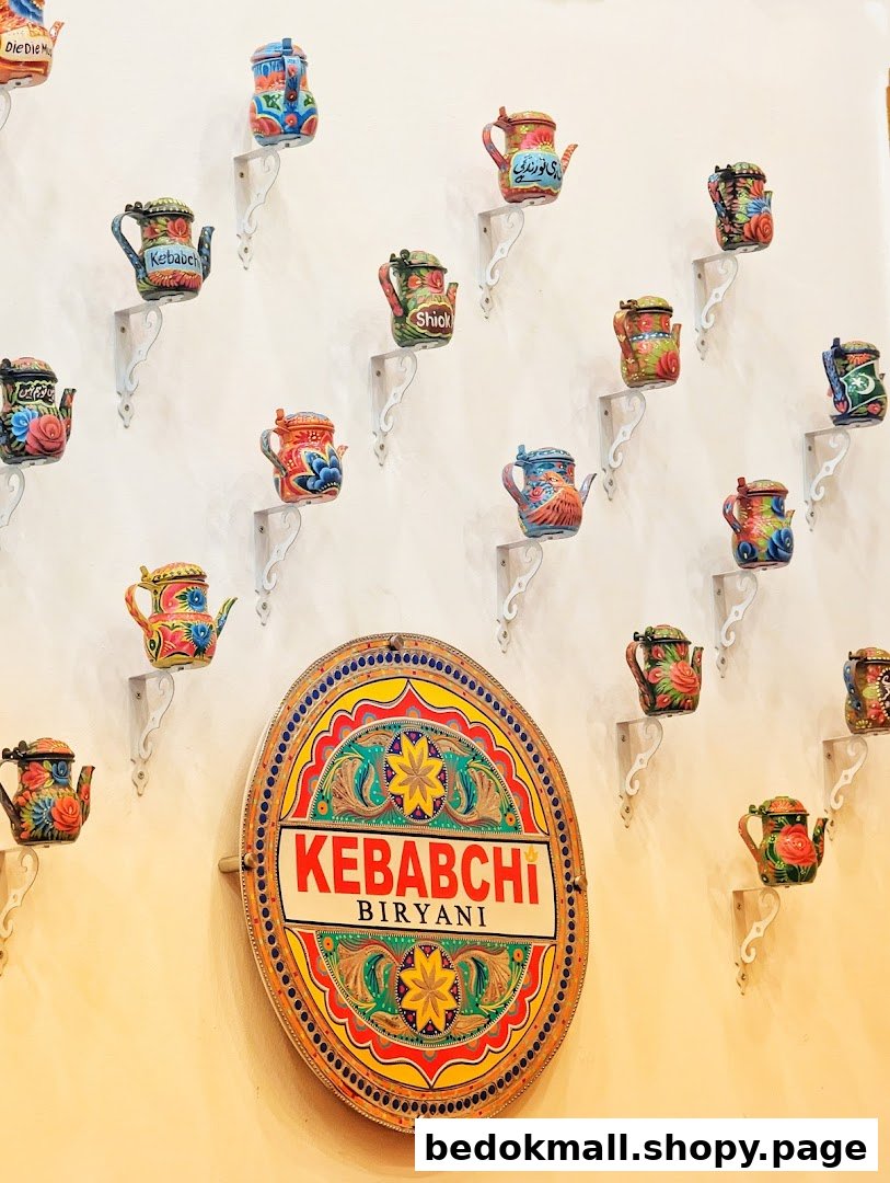 Interior wall with colorful teapots and a Kebabchi Biryani shop sign.