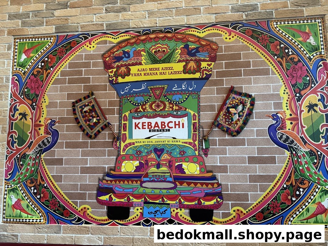 Colorful wall art featuring a truck and peacocks with the shop name.