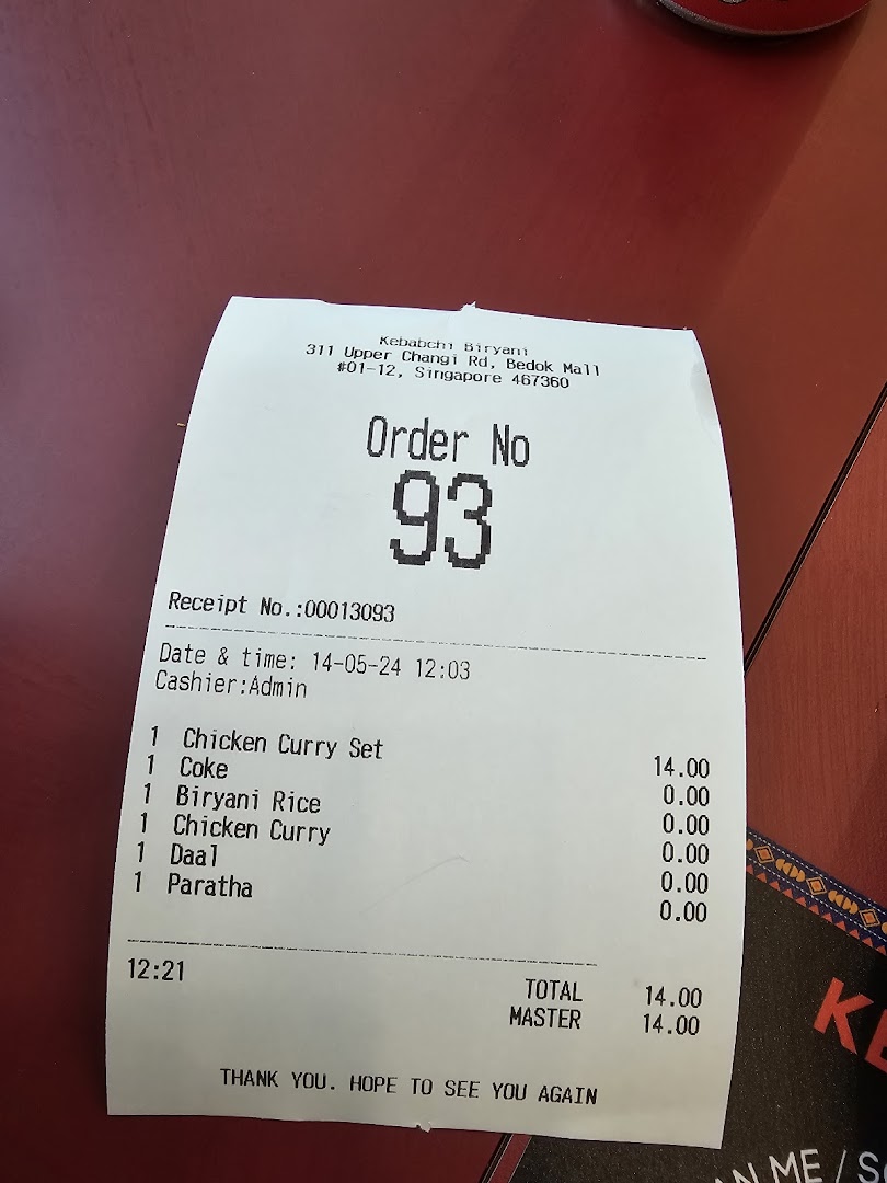 A printed order receipt from Kebabchi Biryani showing food items and total cost.