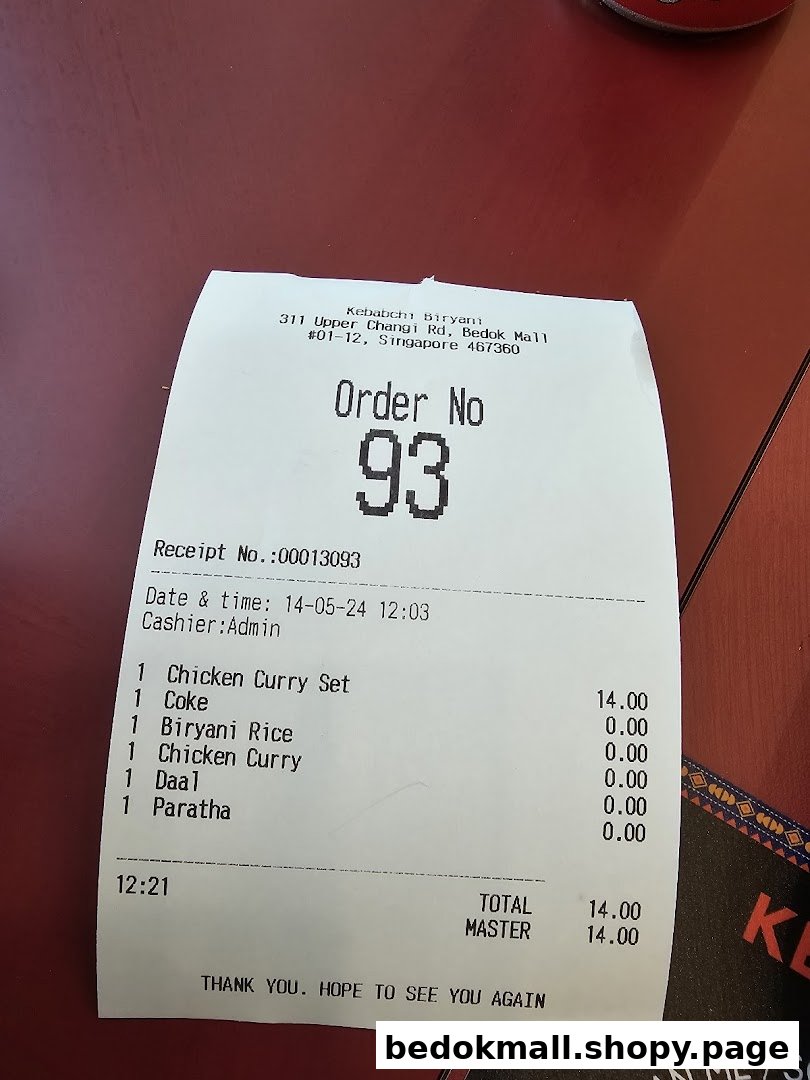A printed order receipt from Kebabchi Biryani showing food items and total cost.