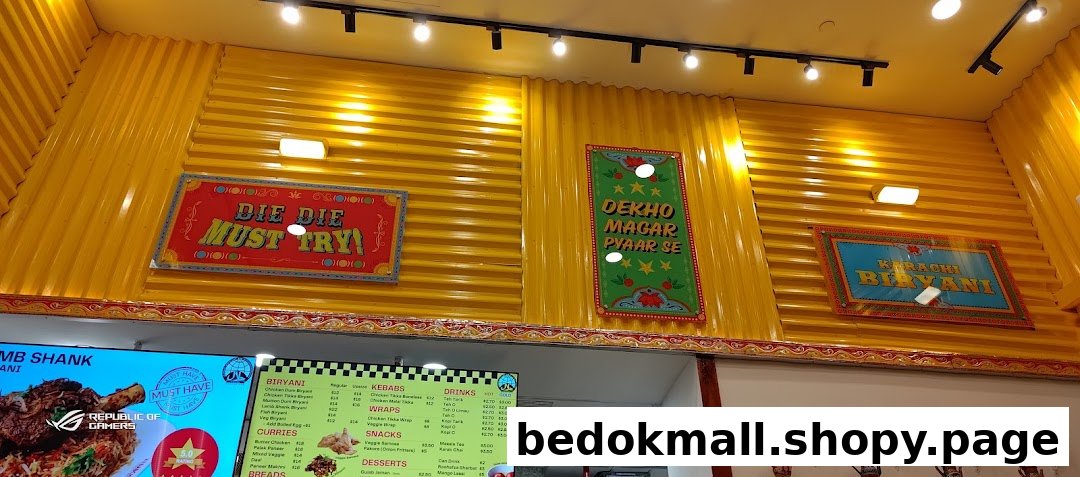 Interior view of a shop with yellow walls and a digital menu board.
