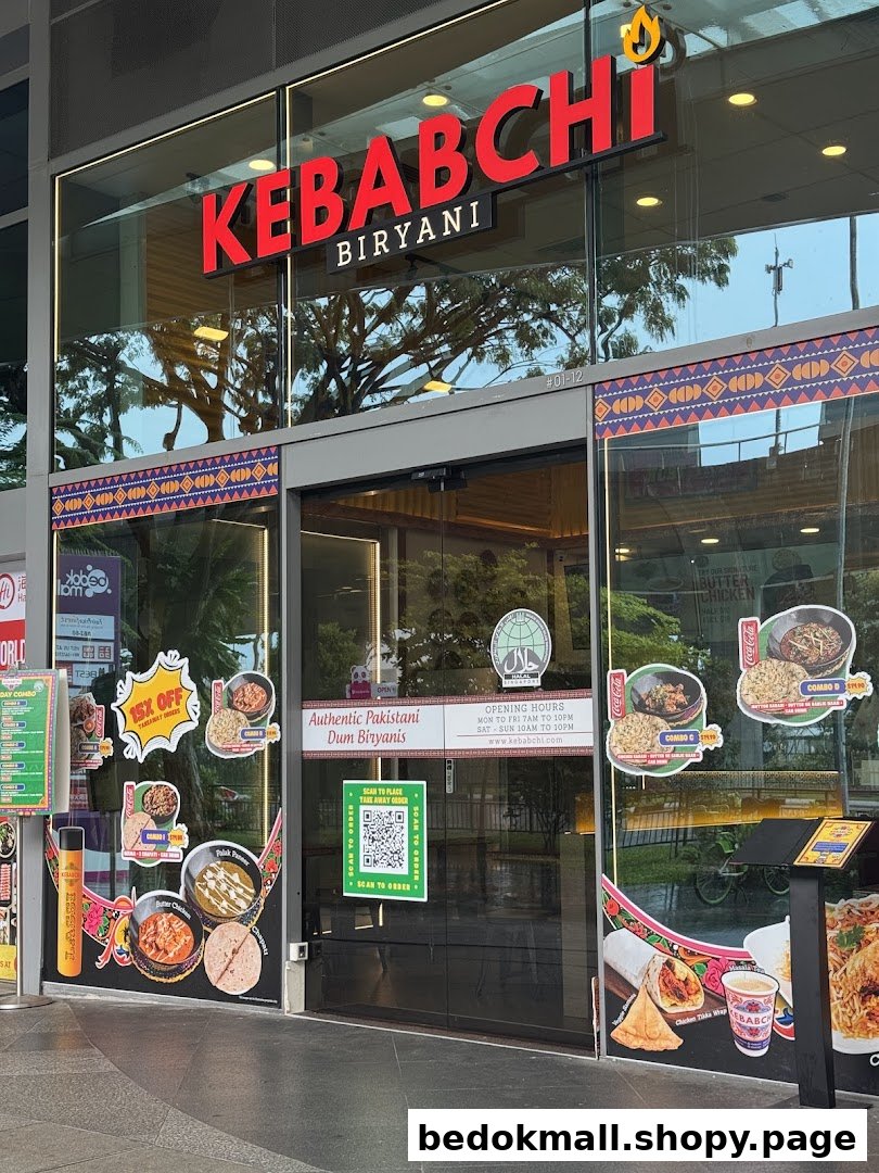 Exterior view of Kebabchi Biryani shop with signage and promotional materials.